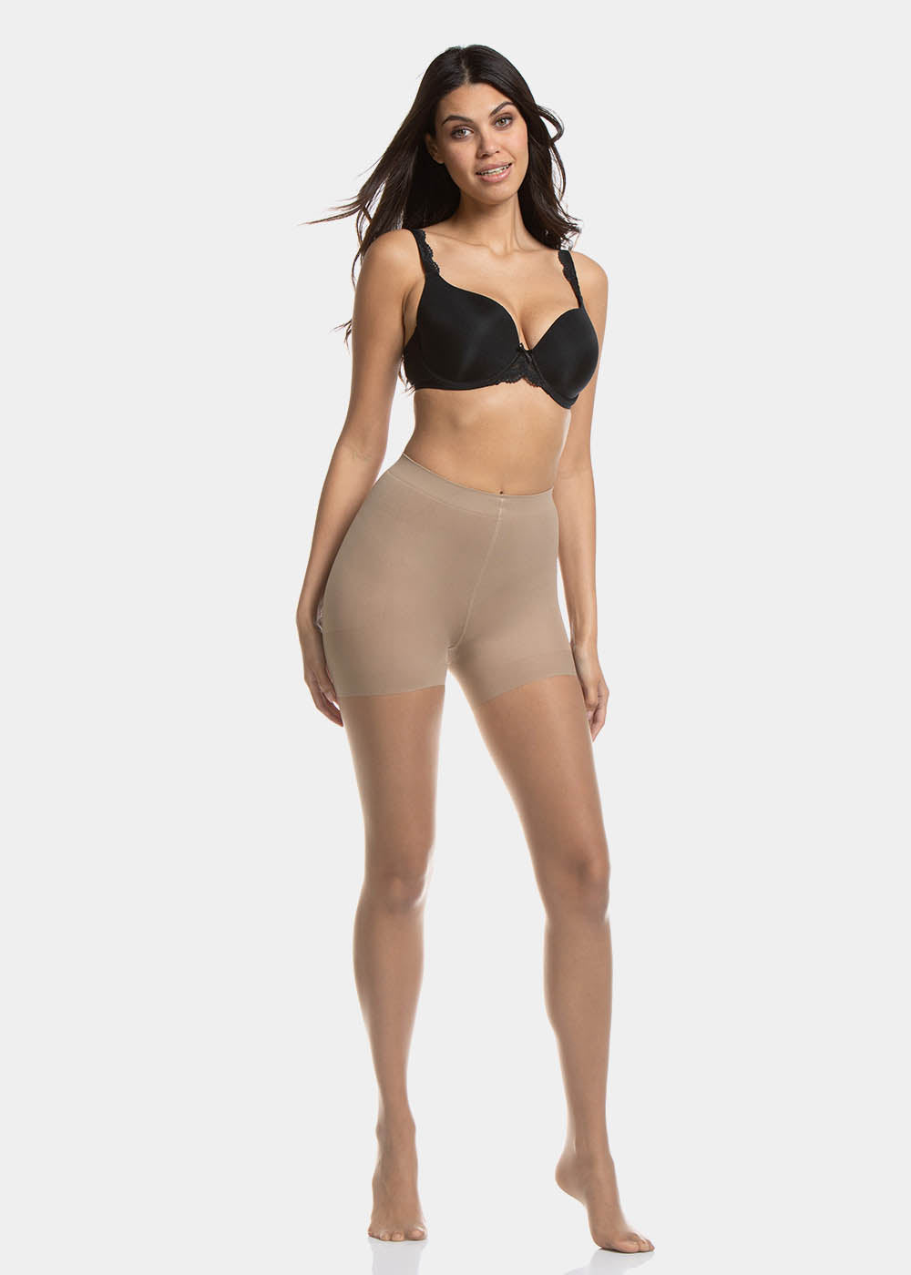 Front view of a model wearing Spectacular Legs in sunkissed, 20 denier shaping tights. Built-in firm shaping shorts providing control for tummy, hips, and upper legs, with subtle lift at the bottom and smooth sheer finish on the legs.