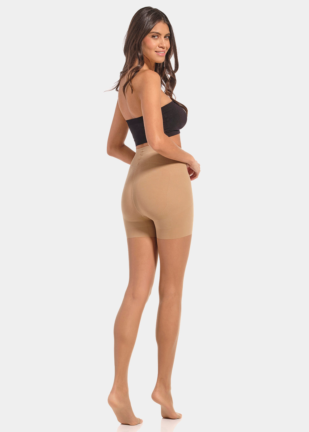 Back view of a model wearing Summer Tights in sunkissed, 20 denier shaping tights with open toe styling. Built-in firm shaping short providing control for lower back, hips, and upper legs, with subtle lift at the bottom and slimming leg effect visible.