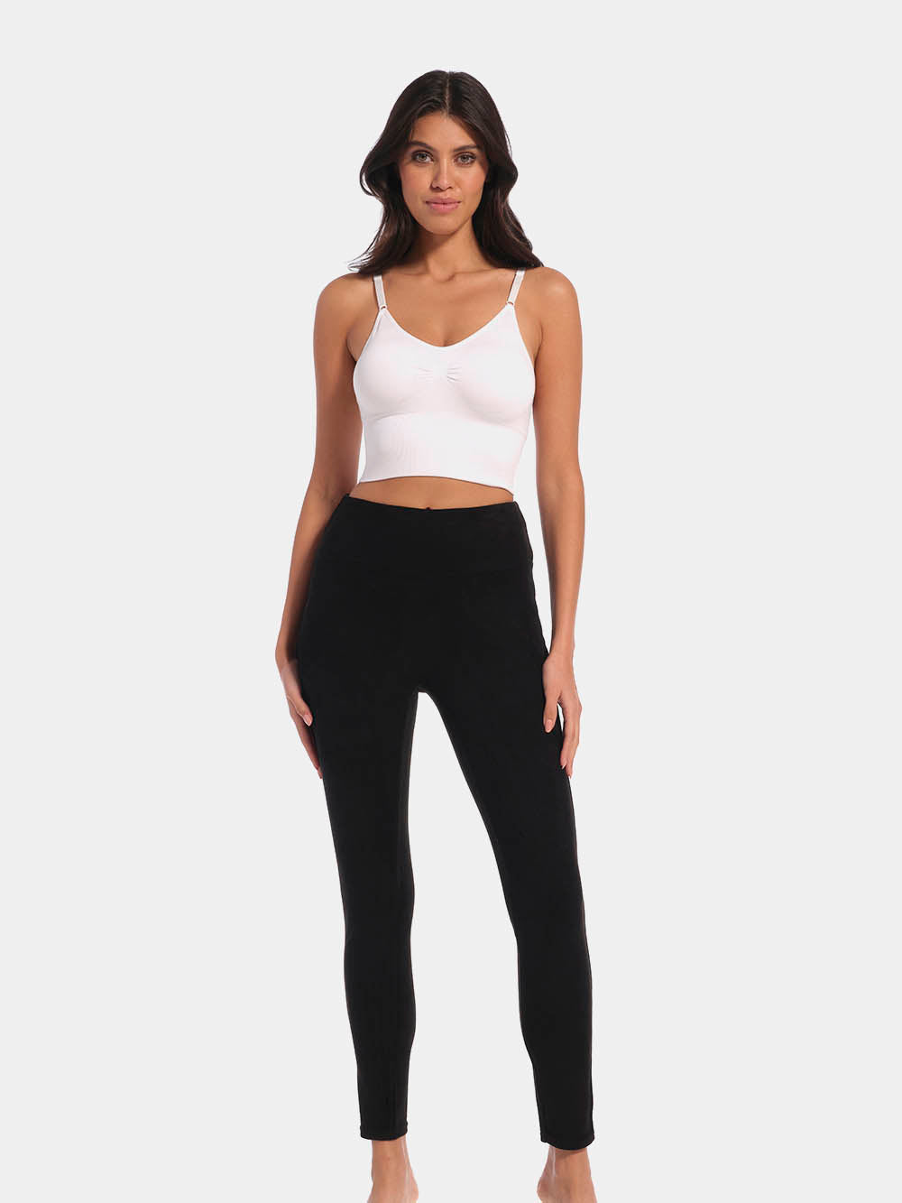 Front view of a model wearing Suedine Look Legging in black, high-rise leggings with built-in shaping briefs. Soft luxurious faux suede stretch fabric providing medium shaping for tummy, hips, and back, with cotton gusset visible.