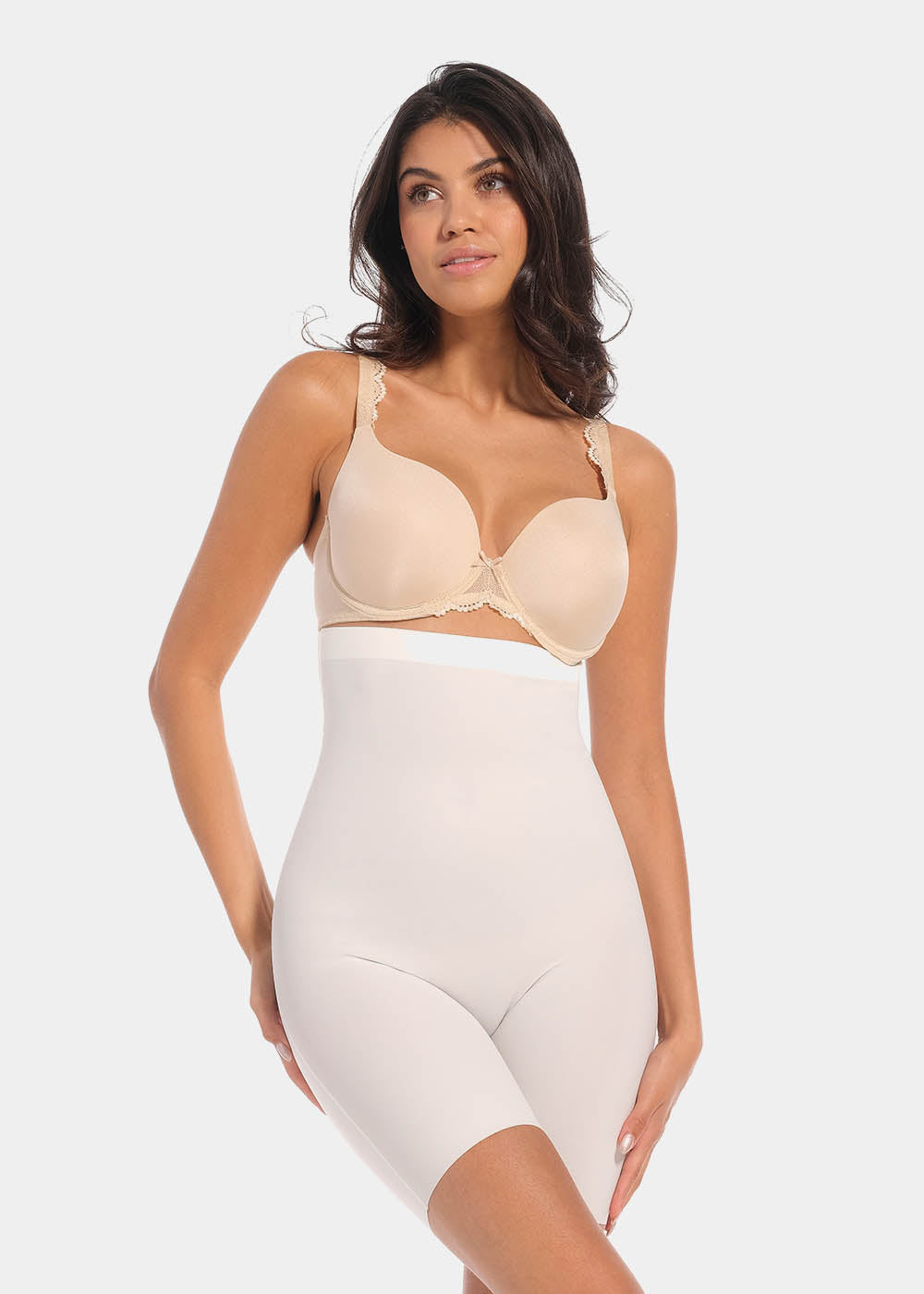 A woman wearing a high-waisted black shapewear Bermuda that extends to mid-thigh.