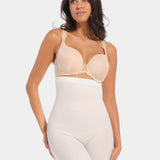 A woman wearing a high-waisted black shapewear Bermuda that extends to mid-thigh.