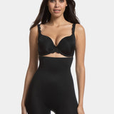 A woman wearing a high-waisted black shapewear Bermuda that extends to mid-thigh.
