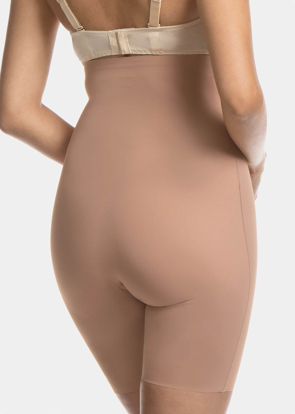 Back view cropped image of a model wearing Maxi Sexy Hi-Bermuda in mocha, high-waist mid-thigh shaping shorts. Smooth powerful fabric with firm control for lower back, hips, and thighs, seamless edges, and silicone-trimmed waistband visible.