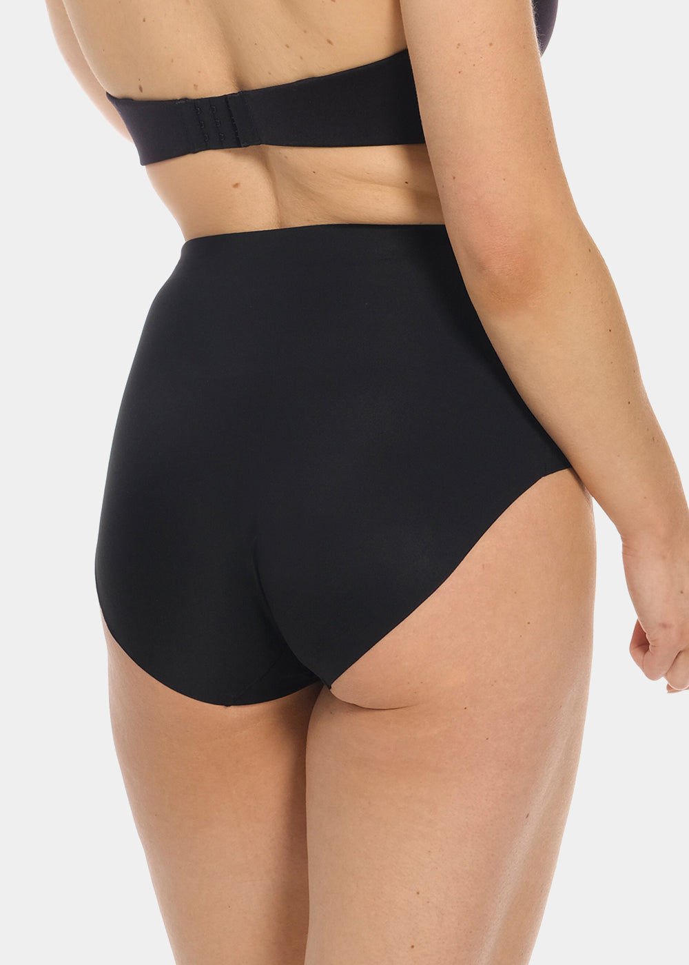 Back view of a model wearing Maxi Sexy Shaping Brief in black, high-waist shaping brief. Smooth strong recycled fabric providing firm control for lower back and waist, with seamless edges for invisible wear under clothing.