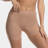 A woman wearing a black maxi sexy short that shapes the lower tummy, hips, and thighs. The short has silicone trim at the leg openings and a seamless edge for an invisible look.
