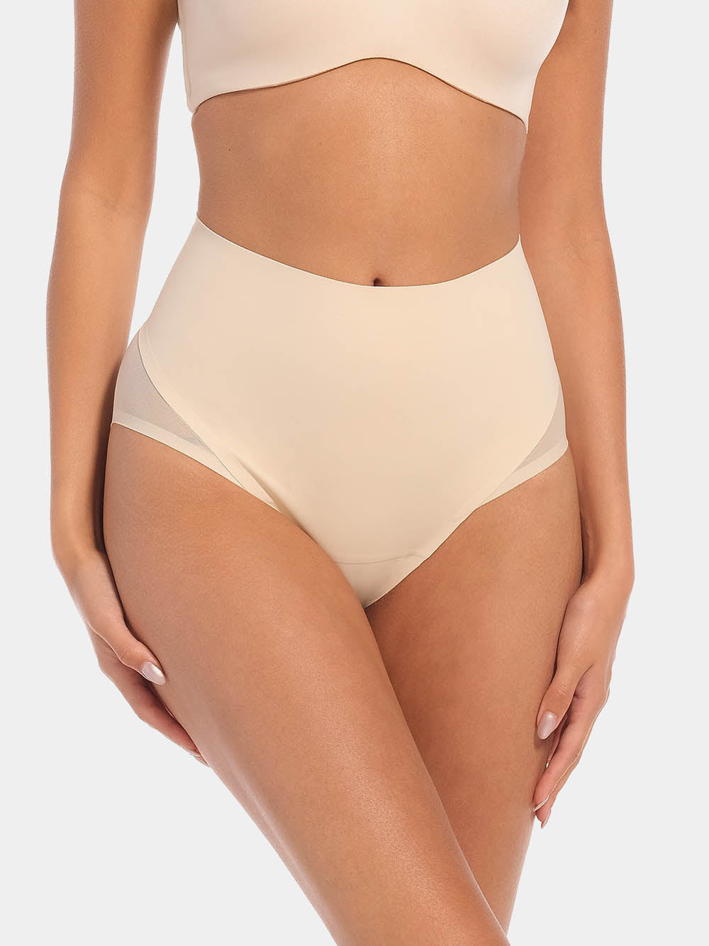 Front view of a model wearing Sheer & Sexy Brief in latte, mid-waist shaping brief. Smooth fabric with sheer mesh panels, medium shaping for tummy and lower back, and special lift zone at the buttocks visible.
