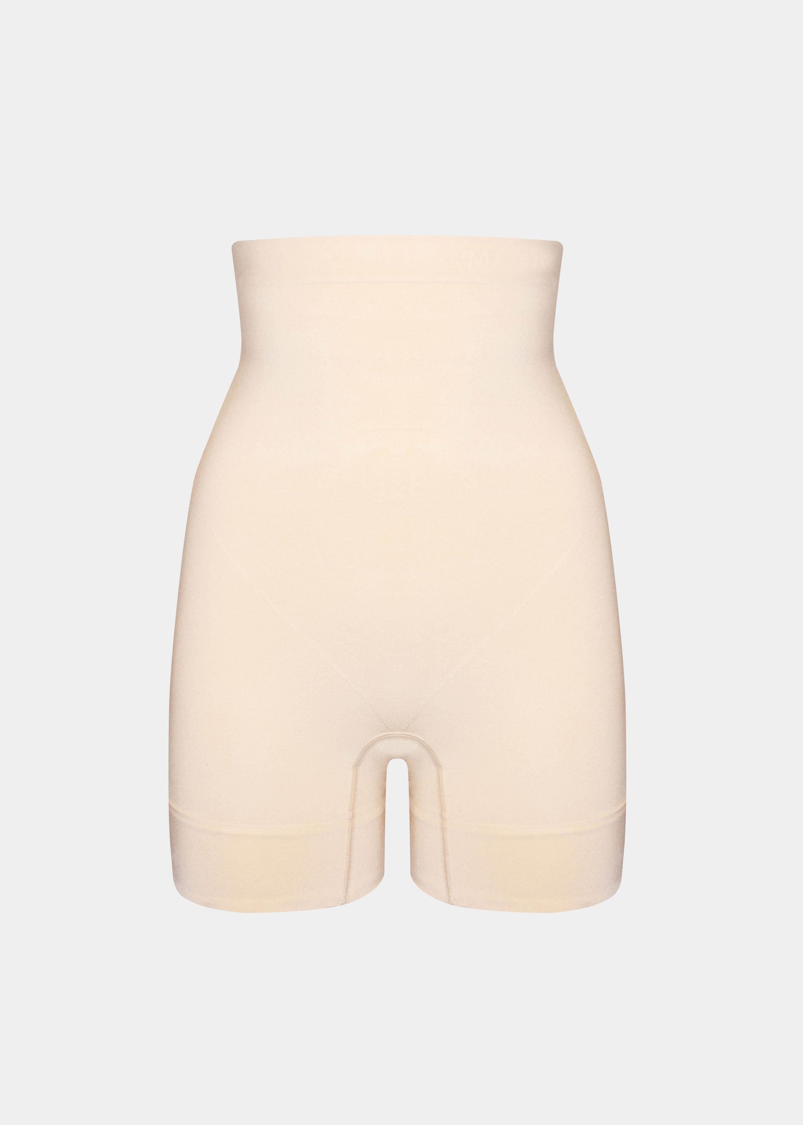 Still product image of Comfort Shaper in latte, high-waist seamless shaping shorts. Smooth stretchable fabric with medium shaping for tummy, waist, back, and thighs, featuring silicone trim at waistband and leg openings and a power zone to lift the bottom.