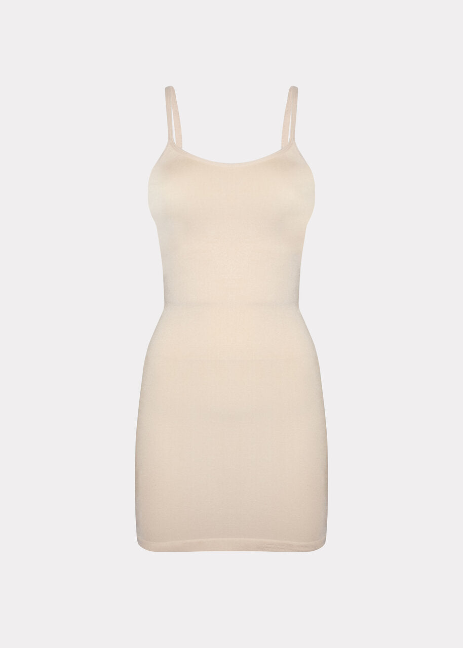 Still product image of Seamless Bodydress in latte, body-contouring shaping dress. Smooth seamless fabric providing medium shaping for tummy, waist, hips, and back, with adjustable spaghetti straps, no bust shaping, and silicone-trimmed hem visible.