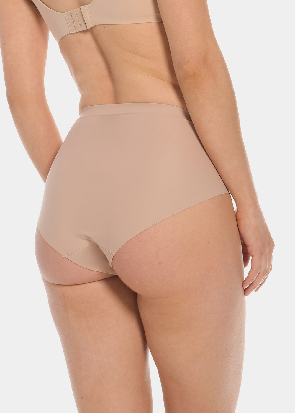 Back view of a model wearing Everyday Shaper Brief in cappuccino, mid-waisted seamless shapewear brief. Smooth fabric with full back coverage and seamless edges, designed for light shaping and invisible wear under clothing.