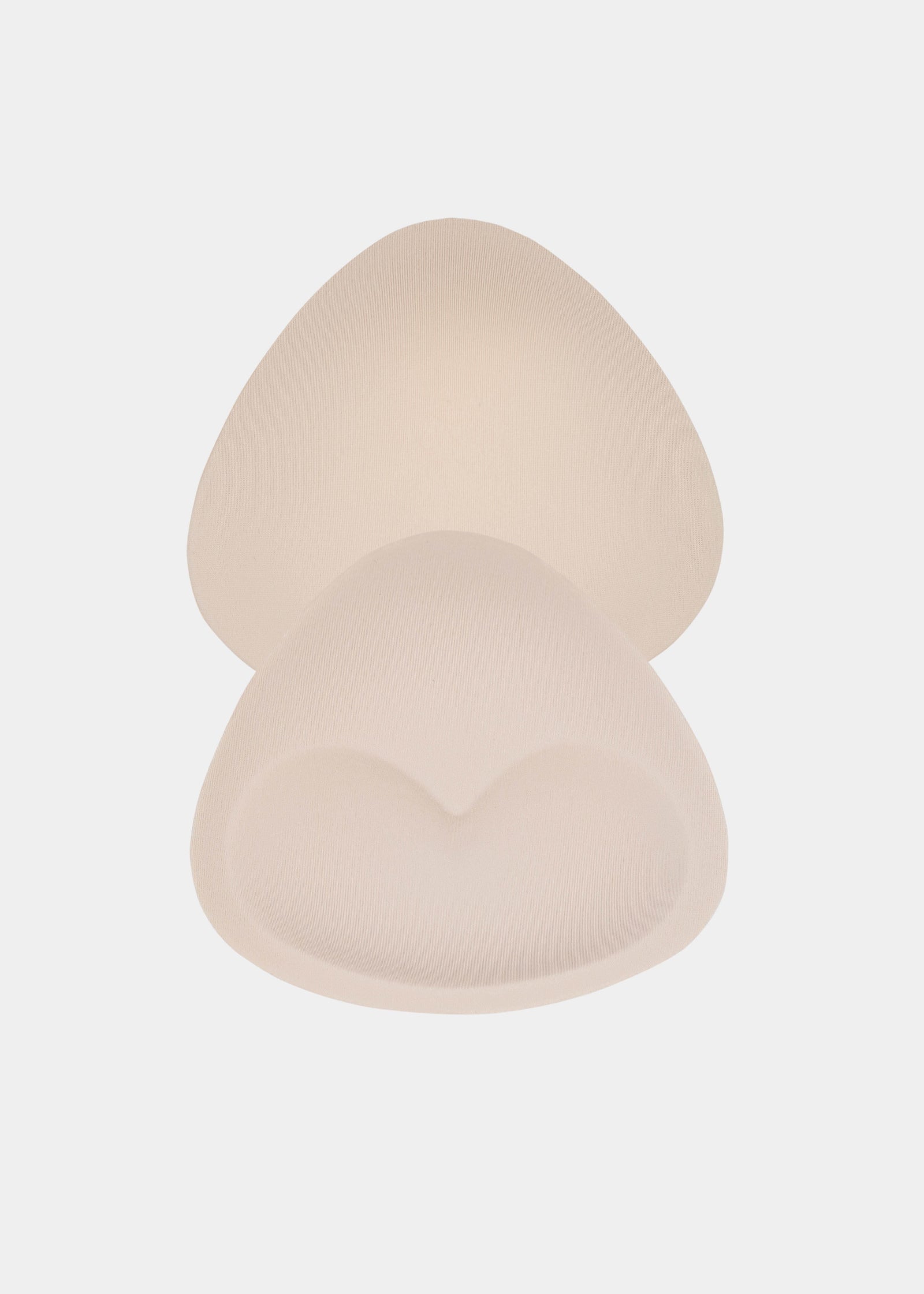 A set of beige-colored push-up bra inserts, designed to be inserted into a bikini top for an enhanced bust line.