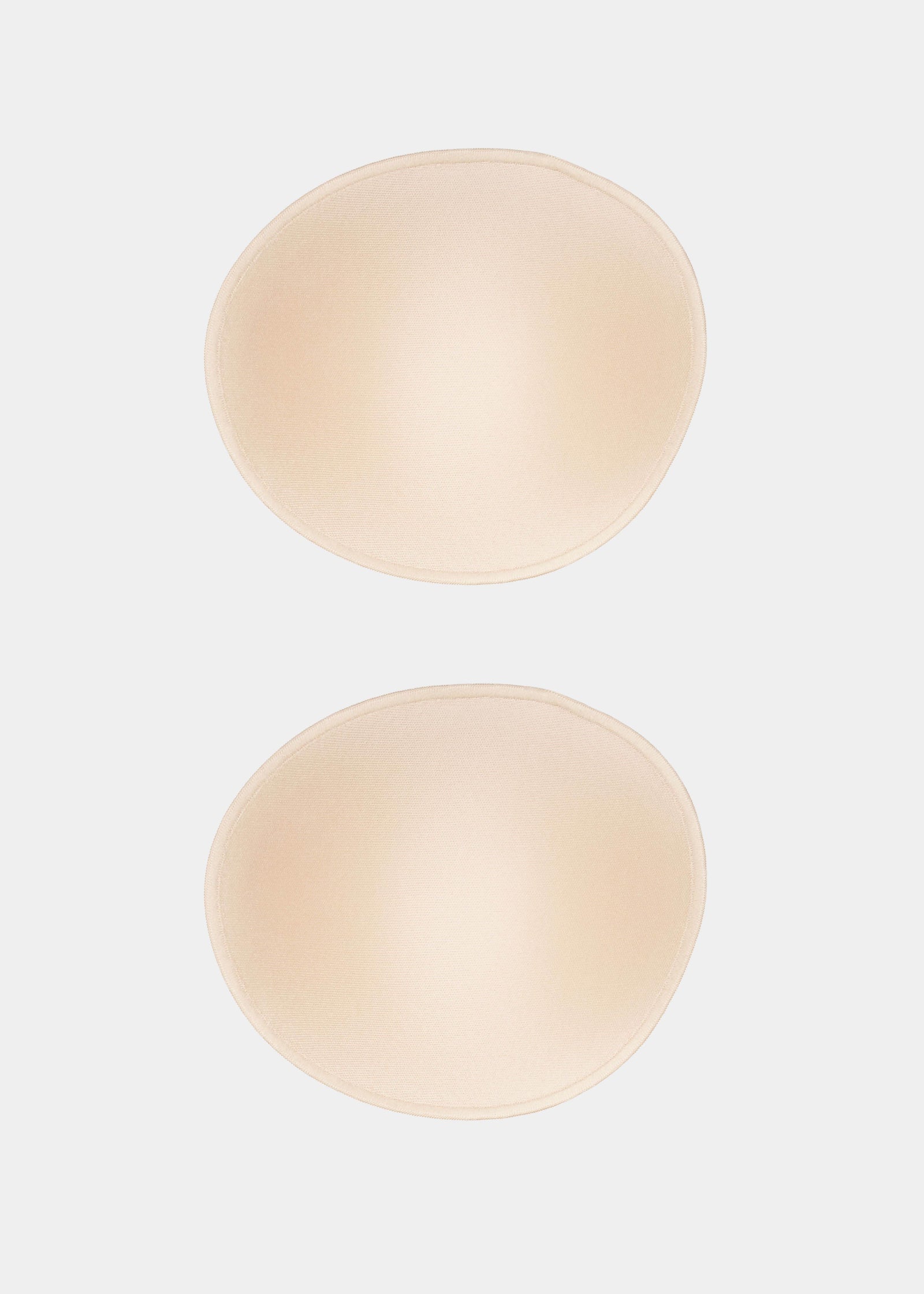 Still product image of MAGIC Cups in latte, soft bra inserts. Full coverage cups with smooth surface, seamless edges, and natural curved shape designed to provide subtle shaping inside bras or clothing.