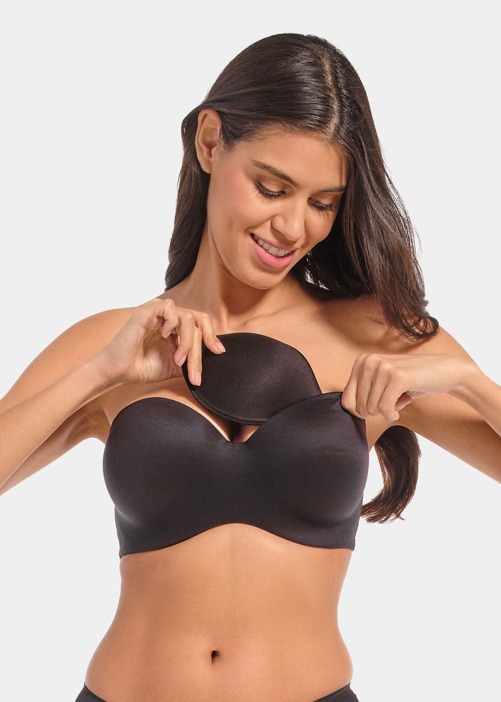 Front view of a model inserting Watersoft Push-Up Bra pads in black, water and oil-filled bra inserts. Full cup pad placed inside bra, showing added volume with smooth surface and curved shape.