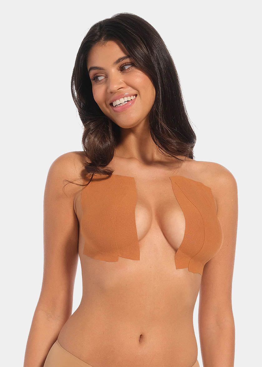 This image features a model demonstrating the use of the Boob Tape XL, which is designed to lift and support breasts without the need for a bra. The tape appears skin-friendly and stretchy, with a beige color that blends well with skin tones.