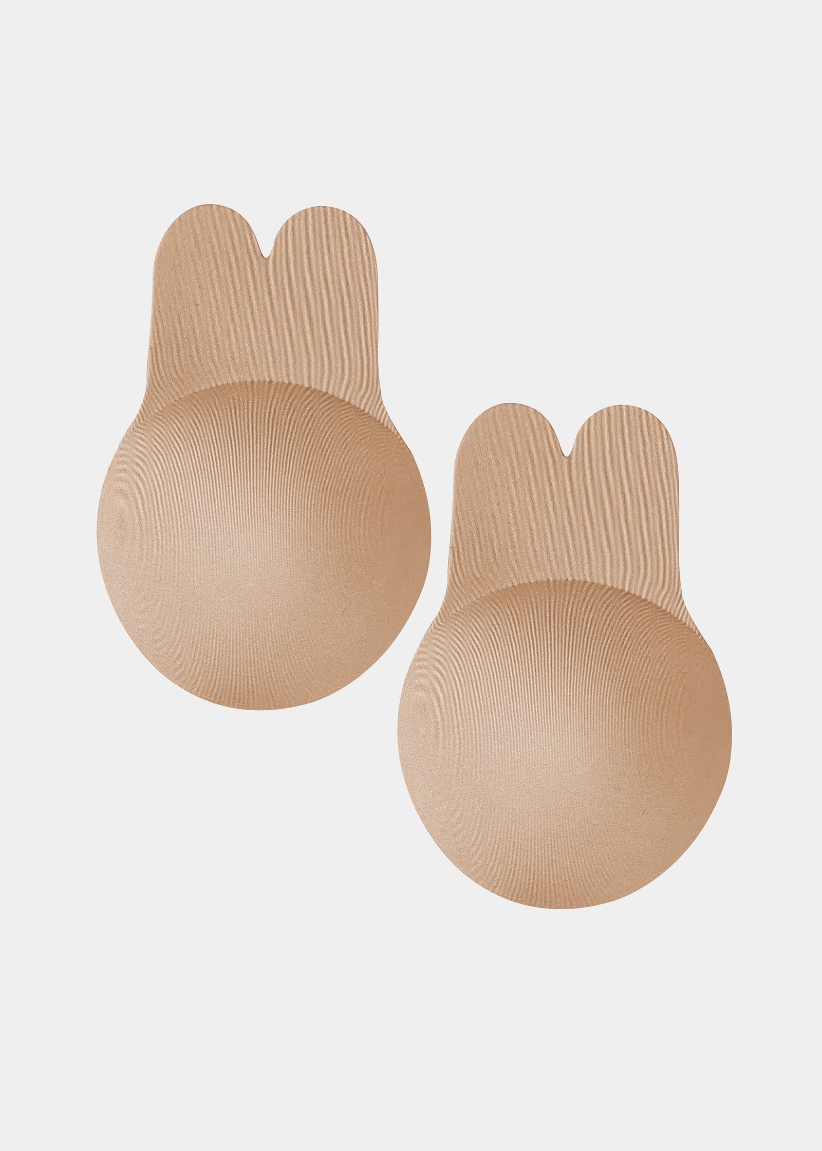 Still front product view of the caramel-colored Lift Covers, showcasing the smooth lifting nipple covers with adhesive support tabs and a seamless finish for invisible coverage.