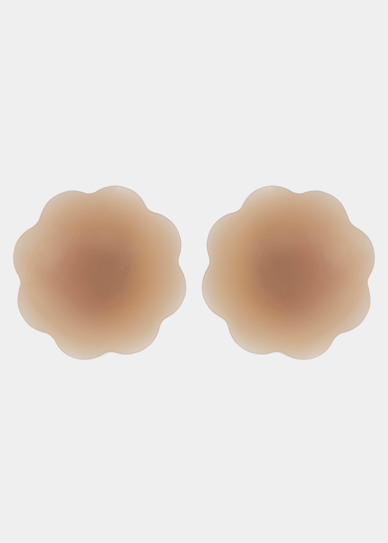 Still product image of Flower Nipples in caramel, flower-shaped silicone nipple covers showing the inside surface. Smooth silicone interior with molded center and seamless edges, designed to create a vacuum effect over the nipple area.
