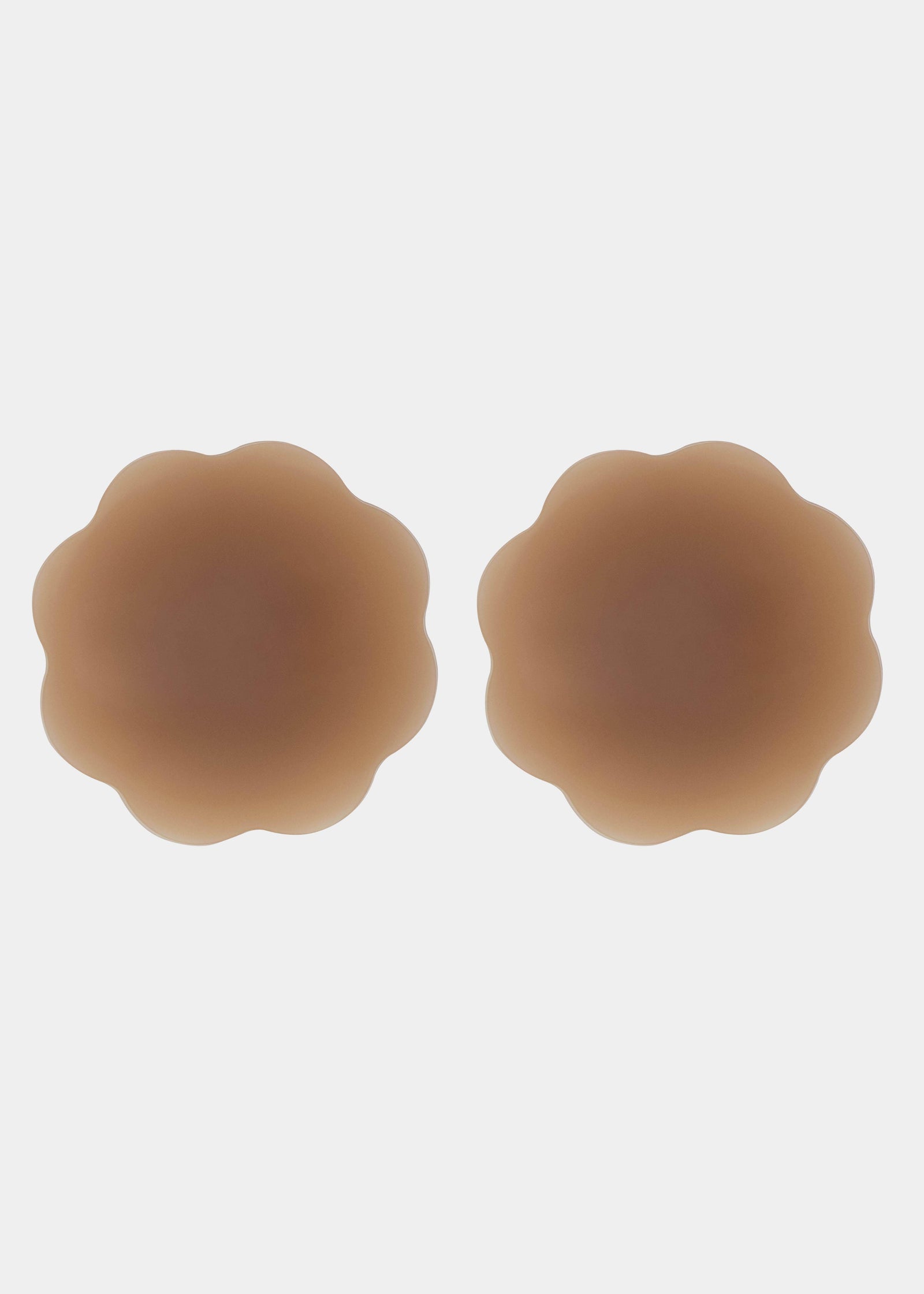 Still product image of Flower Nipples in mocha, flower-shaped silicone nipple covers showing the inside surface. Smooth silicone interior with molded center and seamless edges, designed to create a vacuum effect over the nipple area.