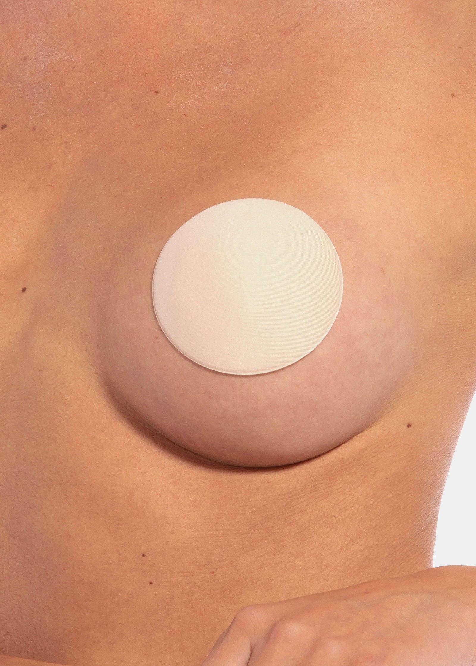 Close-up front view of the latte-colored MAGIC Hide Your Nipples covers, highlighting the soft fabric surface and smooth, ultra-thin edges for discreet, invisible coverage.