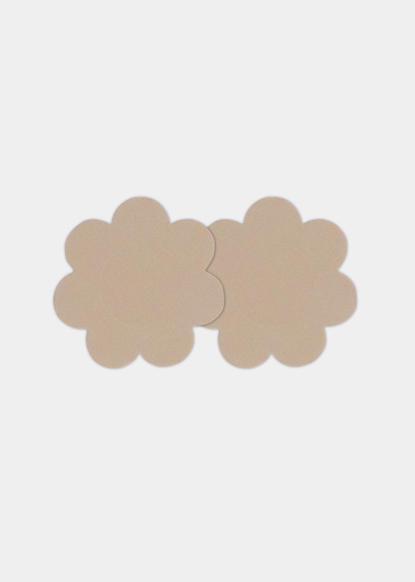 Front view of a model wearing the caramel-colored Secret Covers, featuring soft, flexible nipple covers that provide smooth, discreet coverage with a natural, invisible look under clothing.