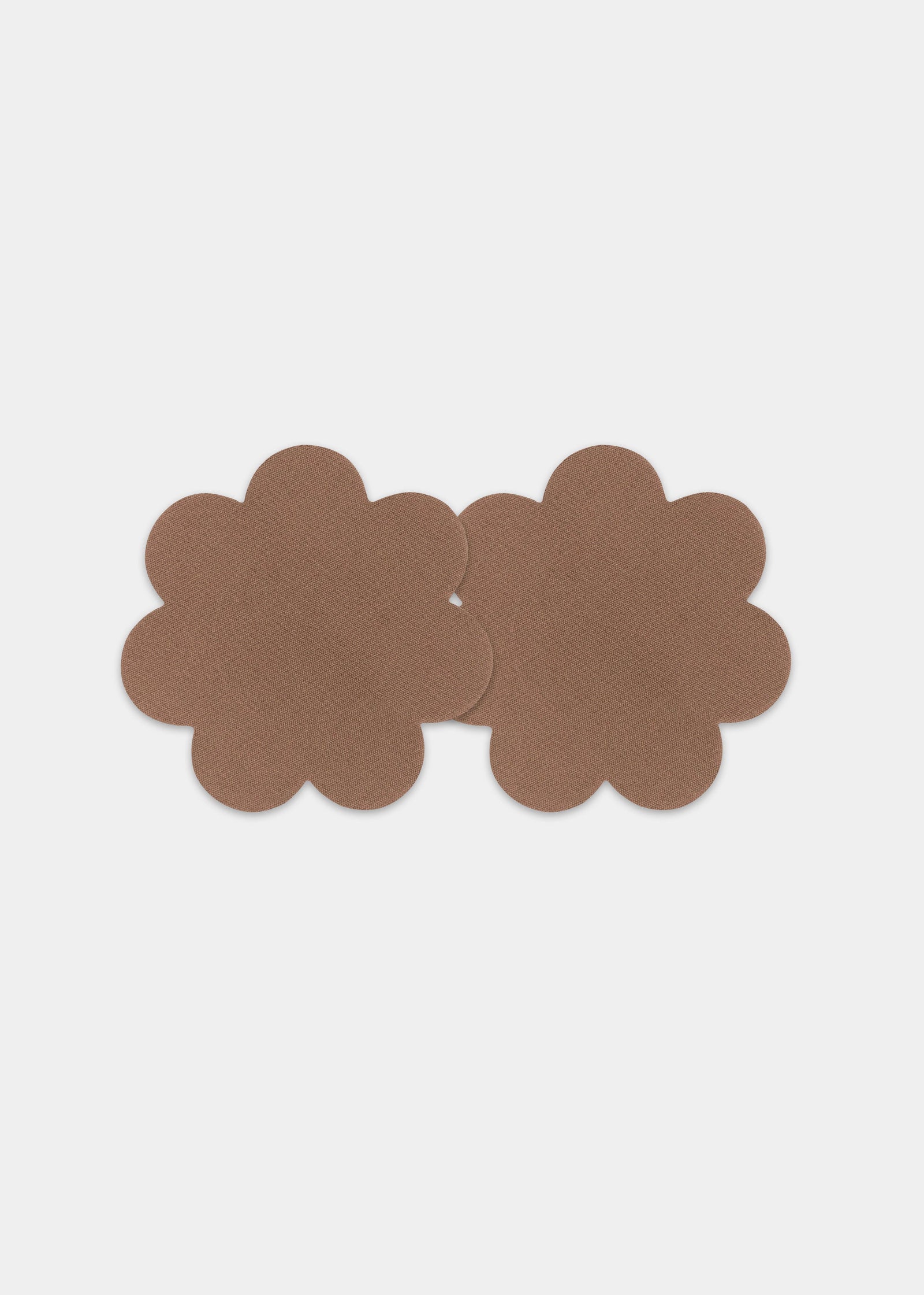 Still front product view of the mocha-colored Secret Covers, showcasing the smooth, soft nipple covers designed for discreet coverage and an invisible look under clothing.