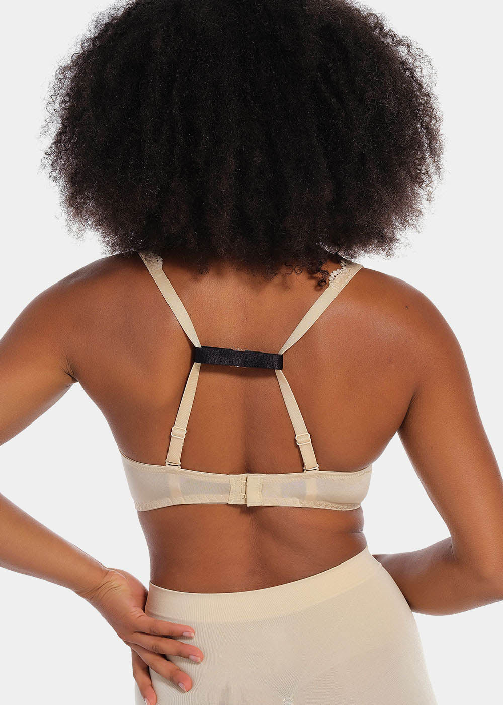 Back view of a model demonstrating different ways to use the Magic Straps, showing how the soft fabric clips pull bra straps together to create a racerback effect and prevent slipping. The image highlights multiple styling options and the discreet fit under clothing.