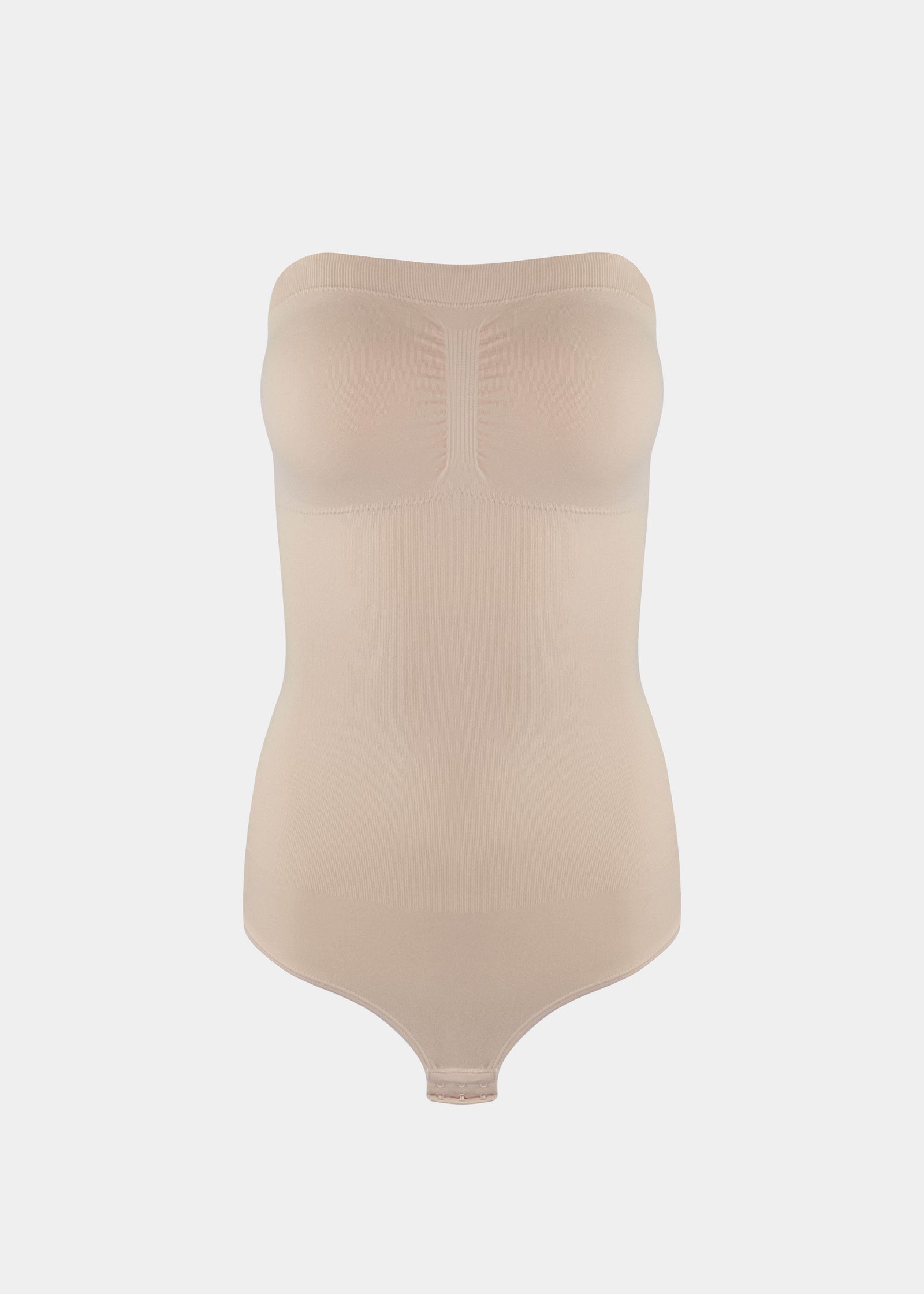 Still front product view of the latte-colored Bandeau Thong Body, highlighting the seamless bandeau neckline with silicone trim, built-in bust support, medium shaping through the waist and tummy, and a smooth, wireless finish.