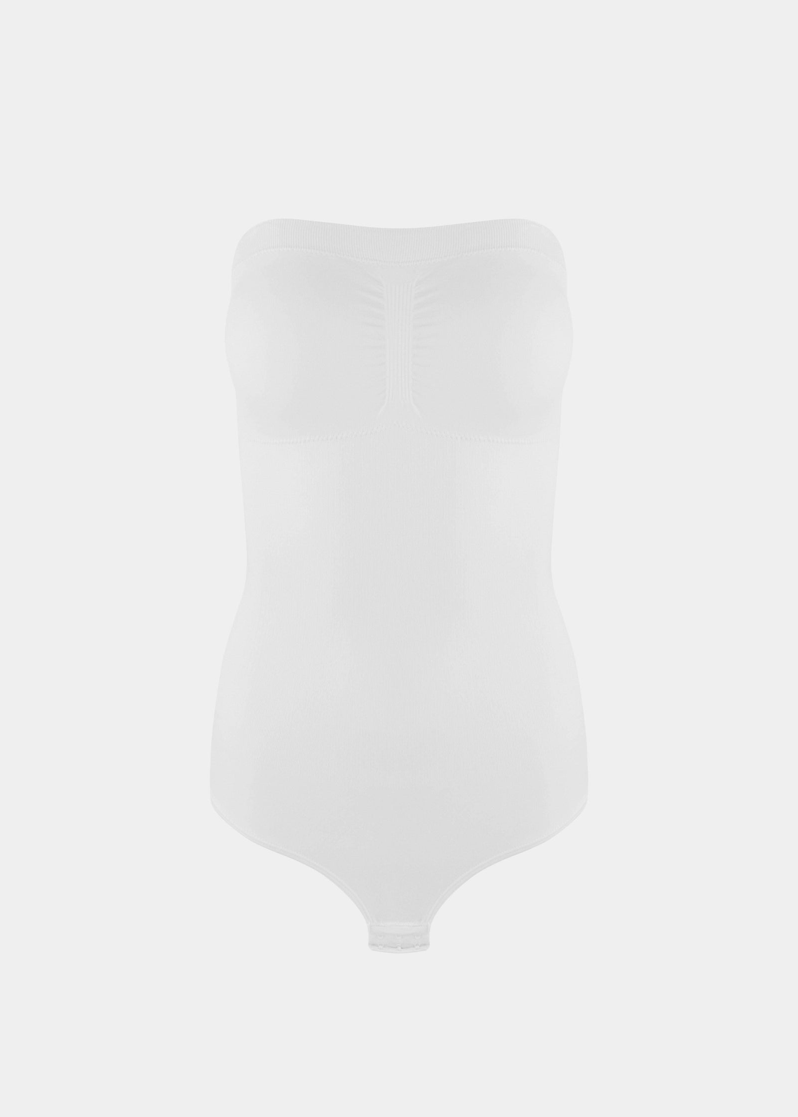 Still front product view of the white Bandeau Thong Body, showcasing the seamless bandeau neckline with silicone trim, built-in bust support, medium shaping through the waist and tummy, and a smooth, wireless finish.