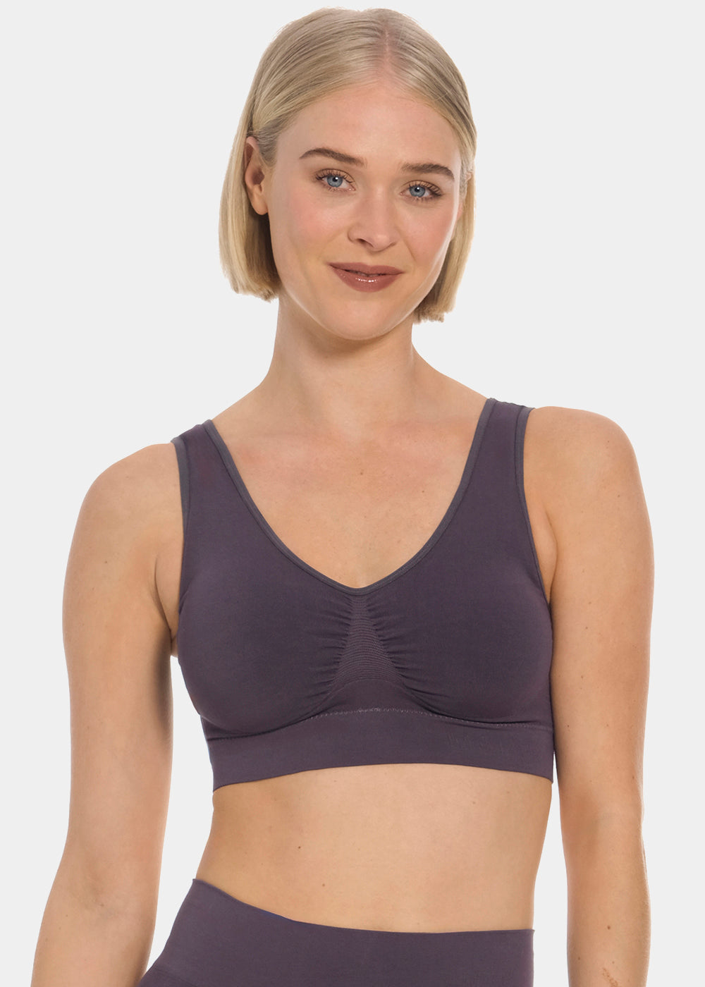 Woman wearing a dark purple Bamboo Comfort Bra and leggings on a white background