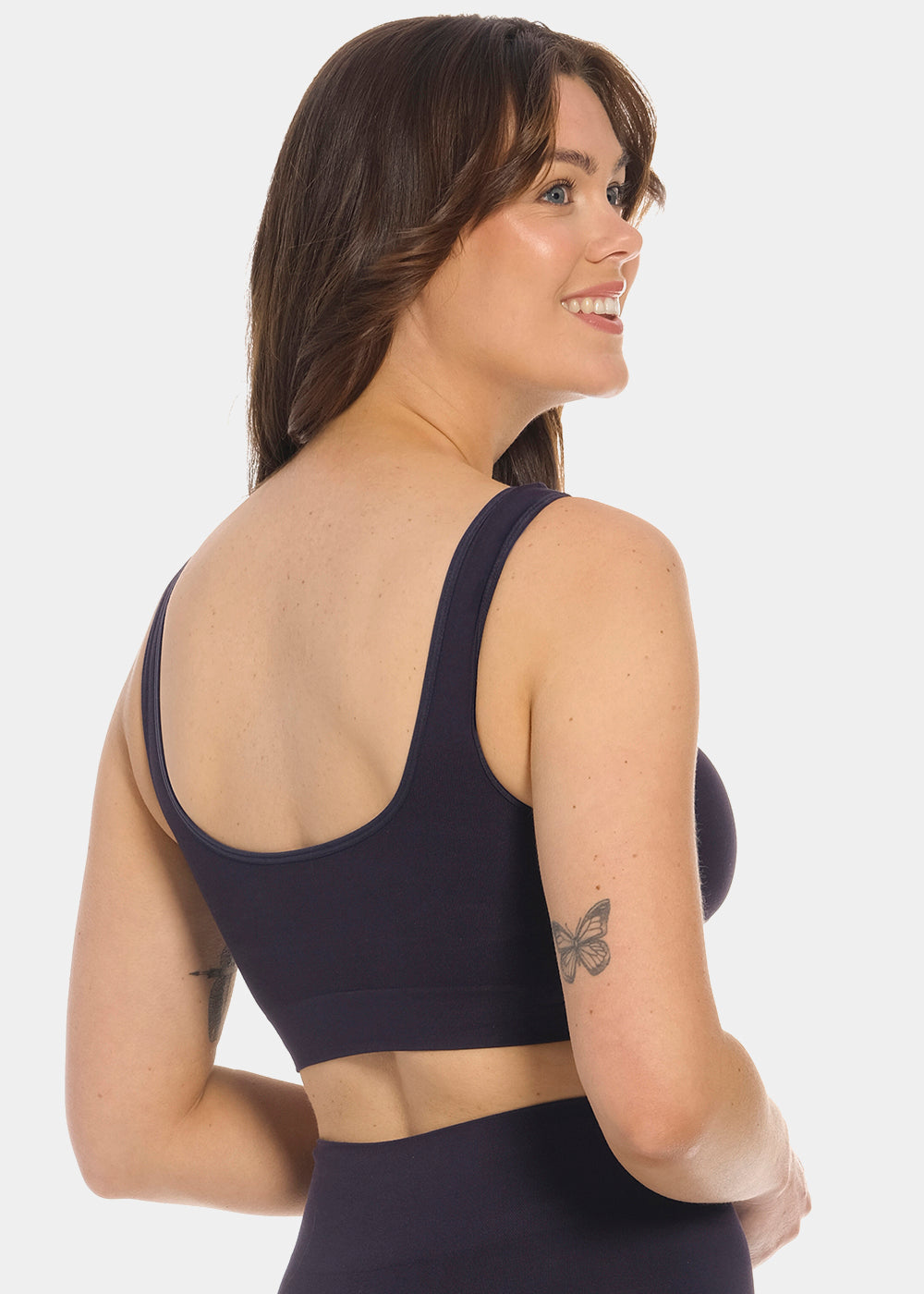 Woman wearing a dark blue Bamboo Comfort Bra and leggings on a white background