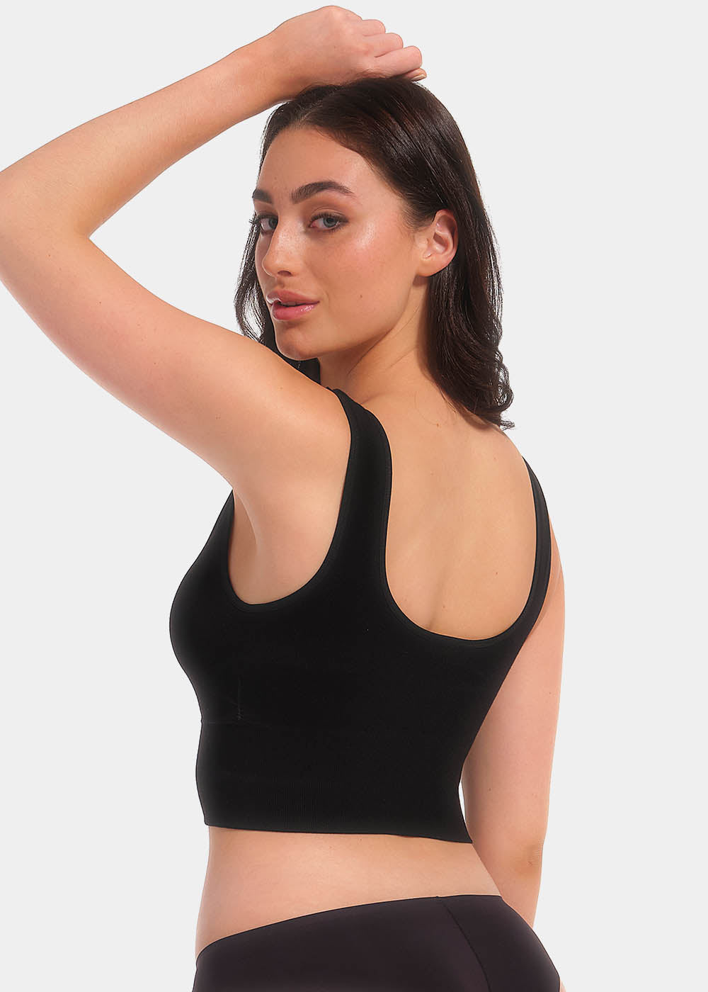 Back view of a model wearing the black Bamboo Shape Bra, showcasing the smooth, seamless bamboo fabric, wide comfortable straps, and a supportive band that provides a secure, shaping fit.