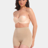 A person wearing a black comfort short that reaches mid-thigh, made of a smooth, solid fabric.