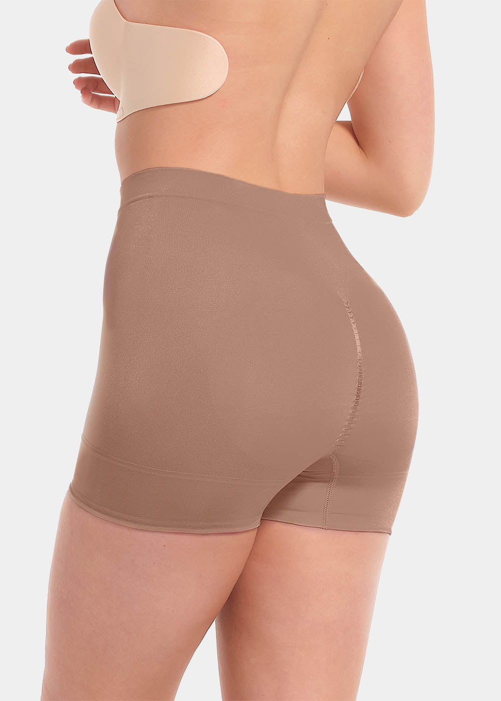 A person wearing a black comfort short that reaches mid-thigh, made of a smooth, solid fabric.