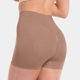 A person wearing a black comfort short that reaches mid-thigh, made of a smooth, solid fabric.