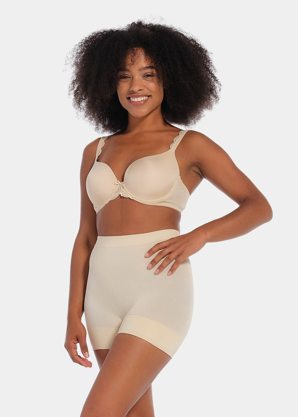 A person wearing a black comfort short that reaches mid-thigh, made of a smooth, solid fabric.