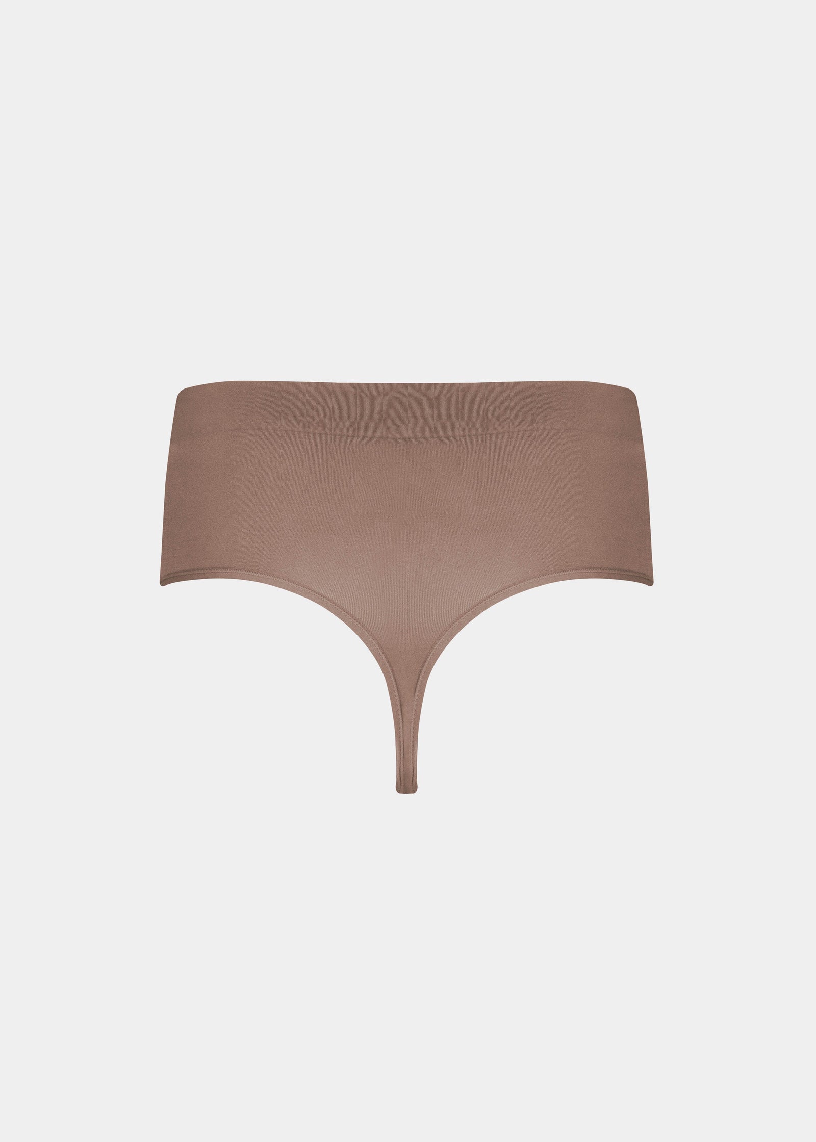 Still back product view of the macchiato-colored Comfort Thong, highlighting the seamless, lightweight fabric, smooth edges, and minimal design for a clean, invisible finish under clothing.