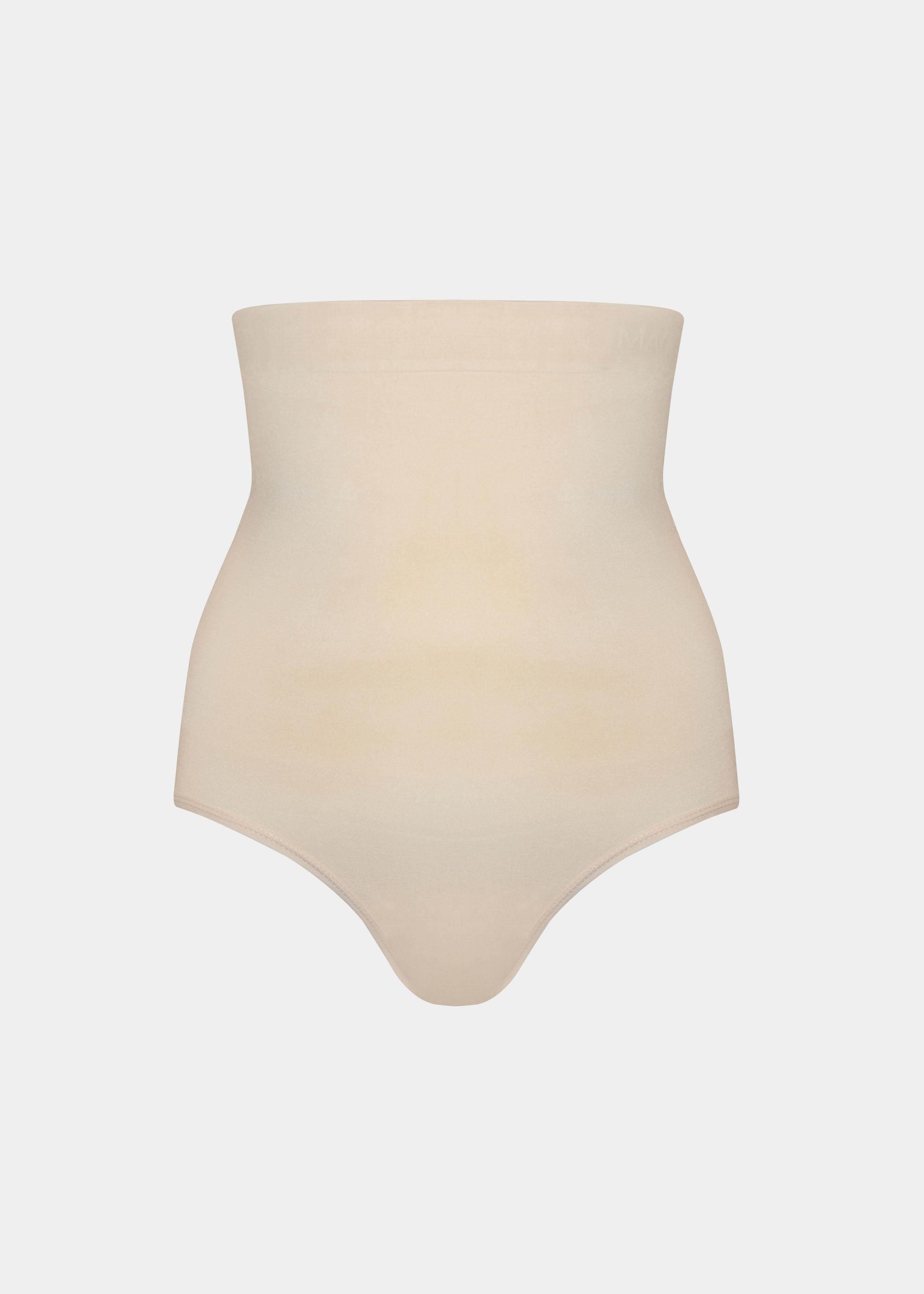 Still front view of a model wearing the Comfort Waistnipper Brief, highlighting the high-waisted seamless design that smooths the tummy and waist, with a clean, invisible finish and a supportive, comfortable fit.