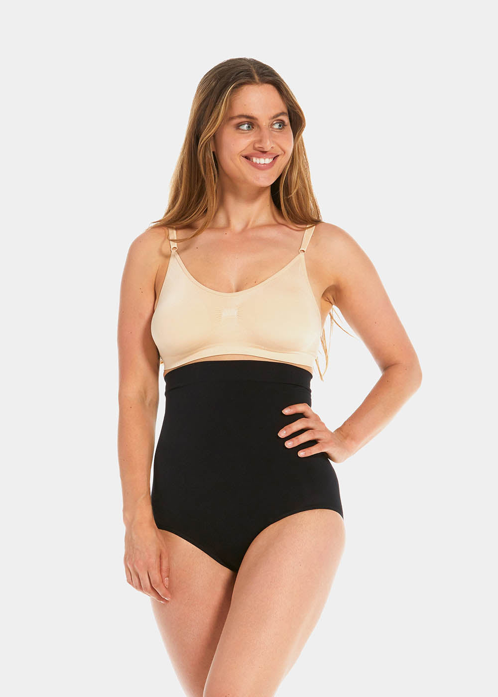 Front view of a model wearing the black Comfort Waistnipper Brief, showing the high-waisted seamless design that smooths the tummy and waist, with a sleek, invisible finish and supportive fit.