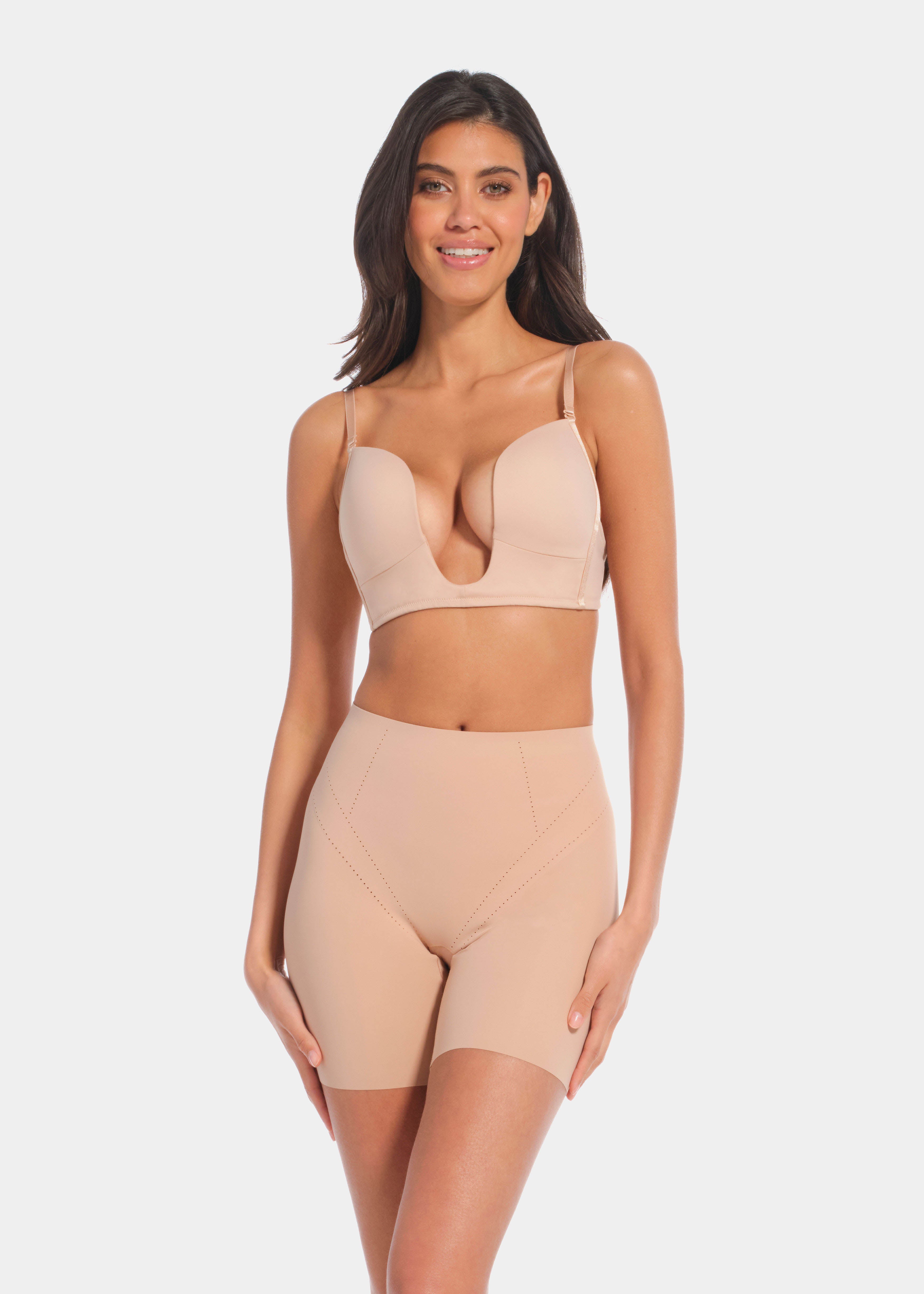 A person wearing a beige Dream Shaper Short that reaches mid-thigh, designed for shaping the lower back, tummy, and upper legs.