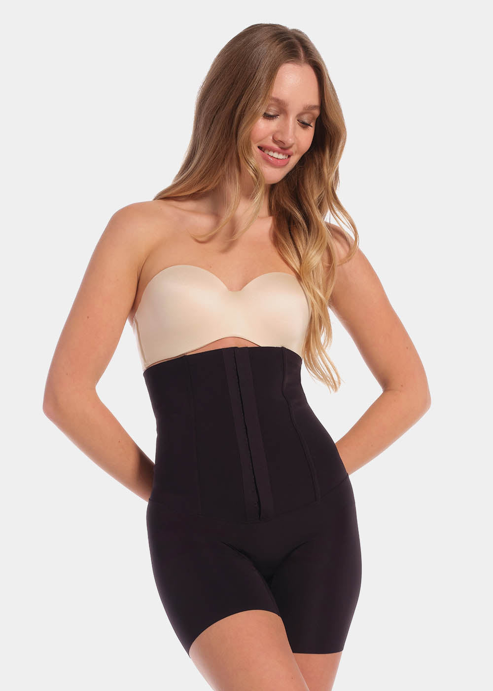 A model wearing high-waisted black Body Control Bermuda with a hook-and-eye front closure.