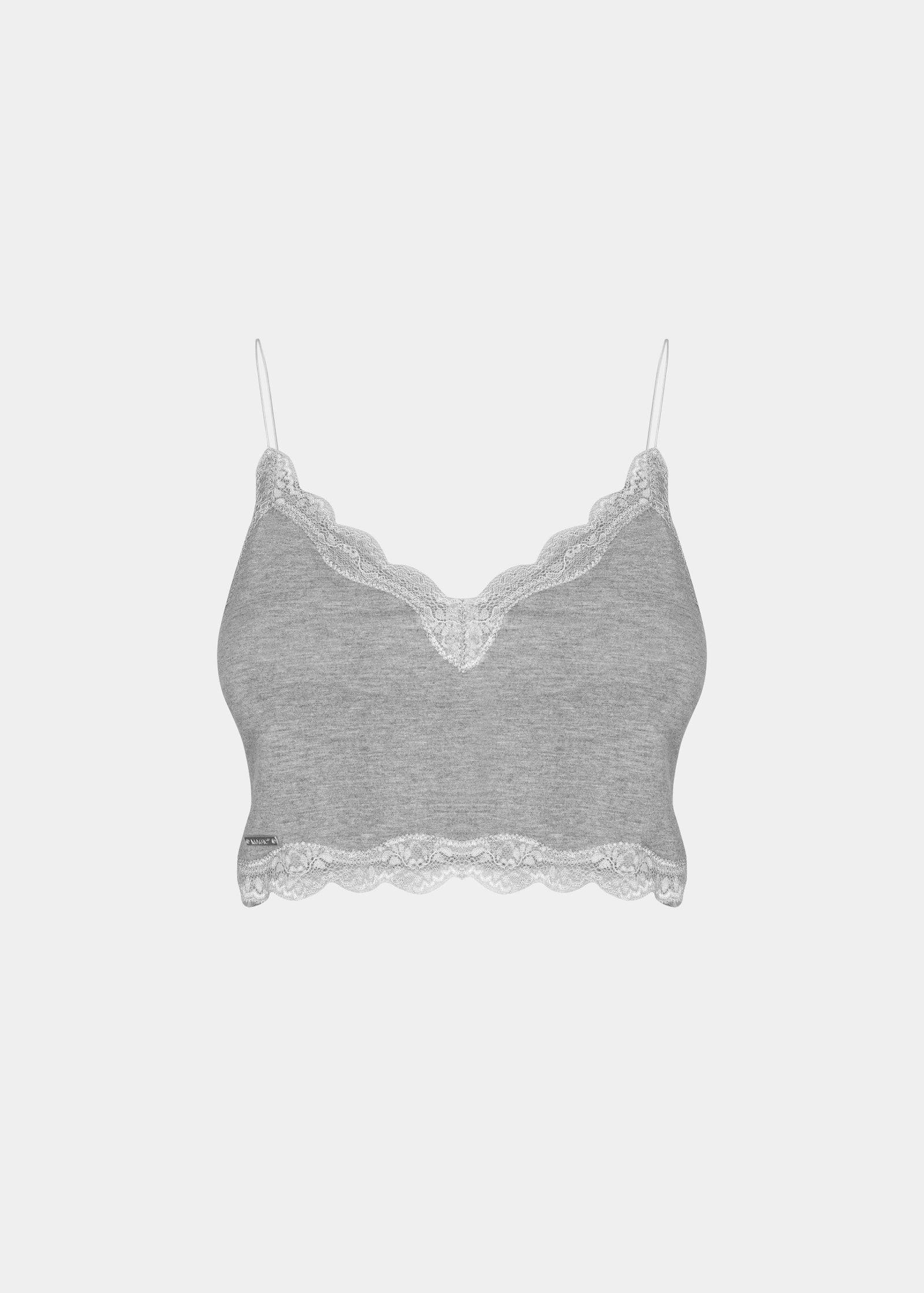 this picture shows a white cozy crop top with V-neckline and lace detail, with ultra thin spaghetti straps. (still front view)