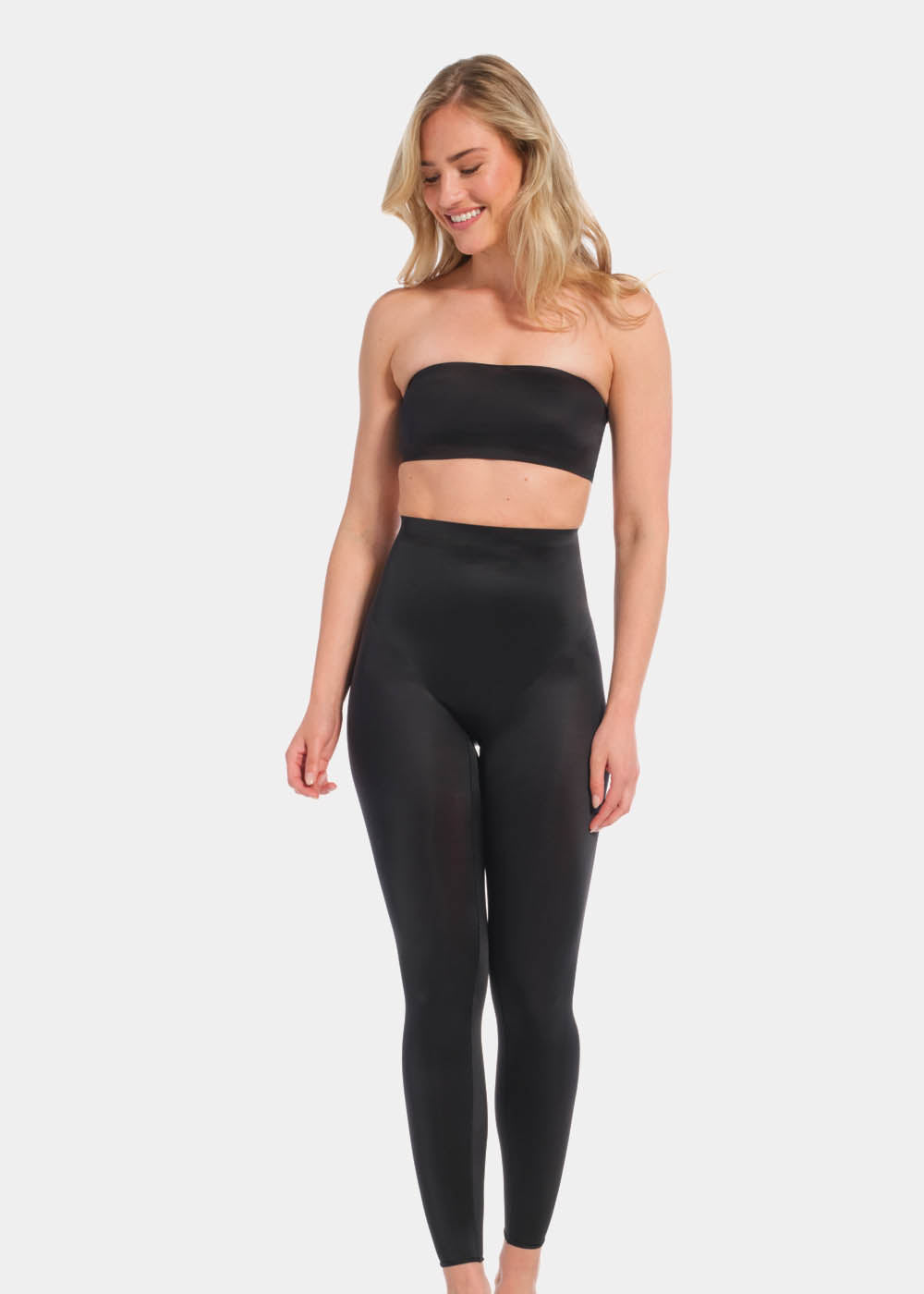 A woman wearing a black Gloss Legging with a high waist, standing against a white background.