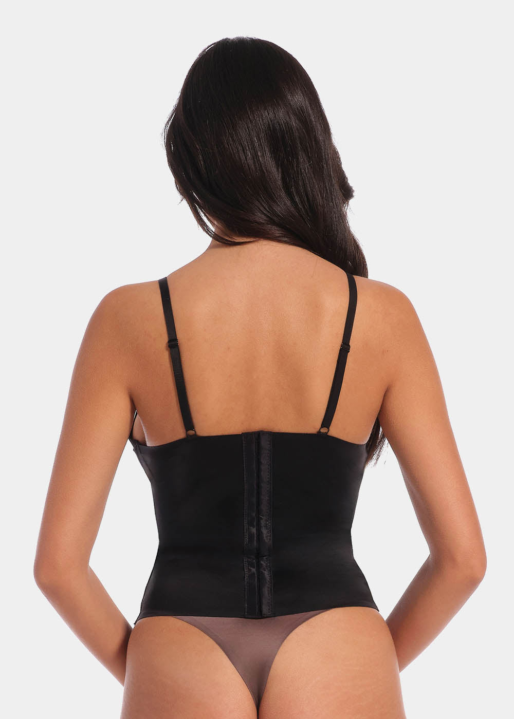 A woman wearing the Gloss Low Plunge Top. Showing the straps and back of the product.
