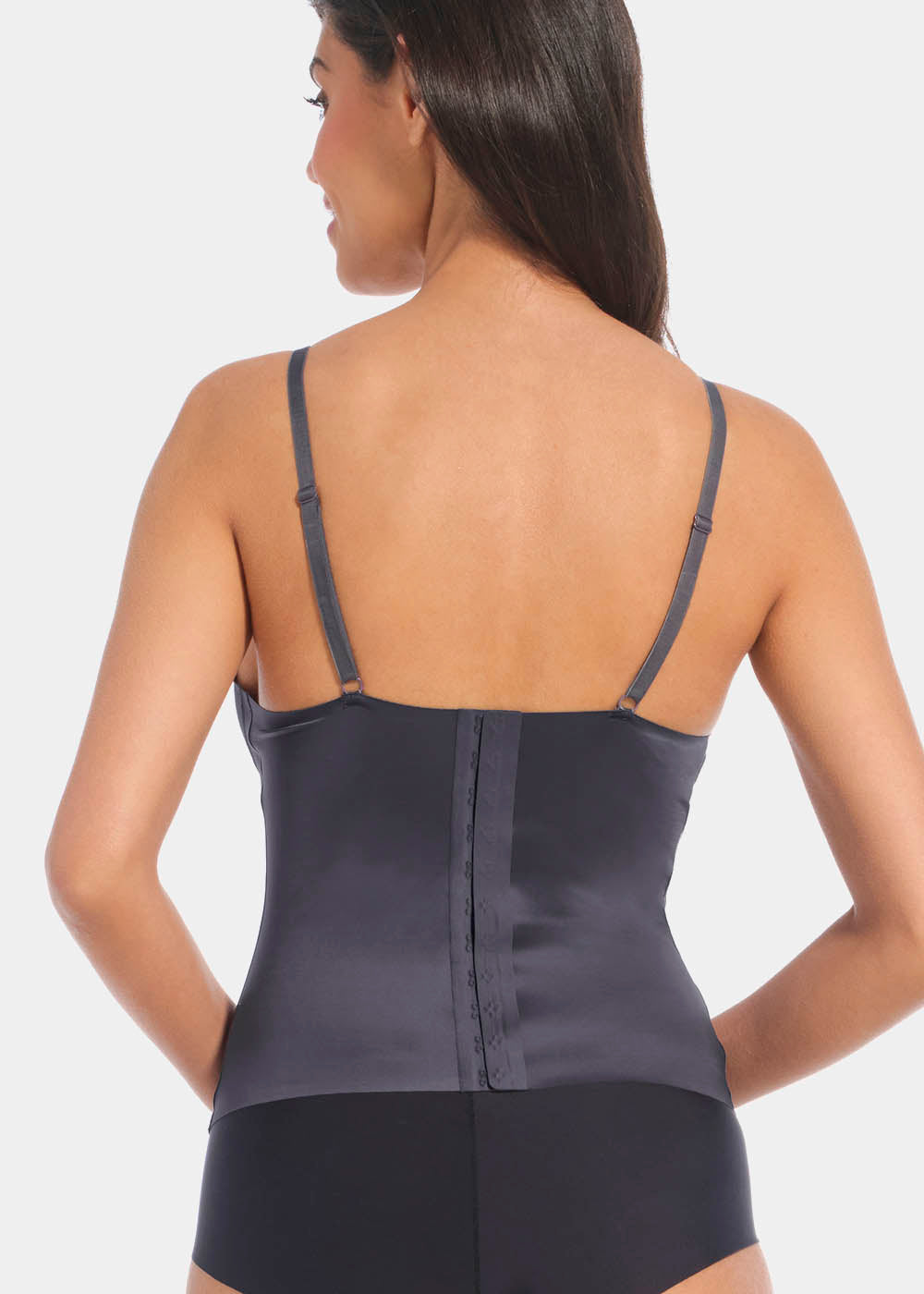 A model wearing the Gloss Low Plunge Top. Showing it from the back to show the straps and hook and closure back
