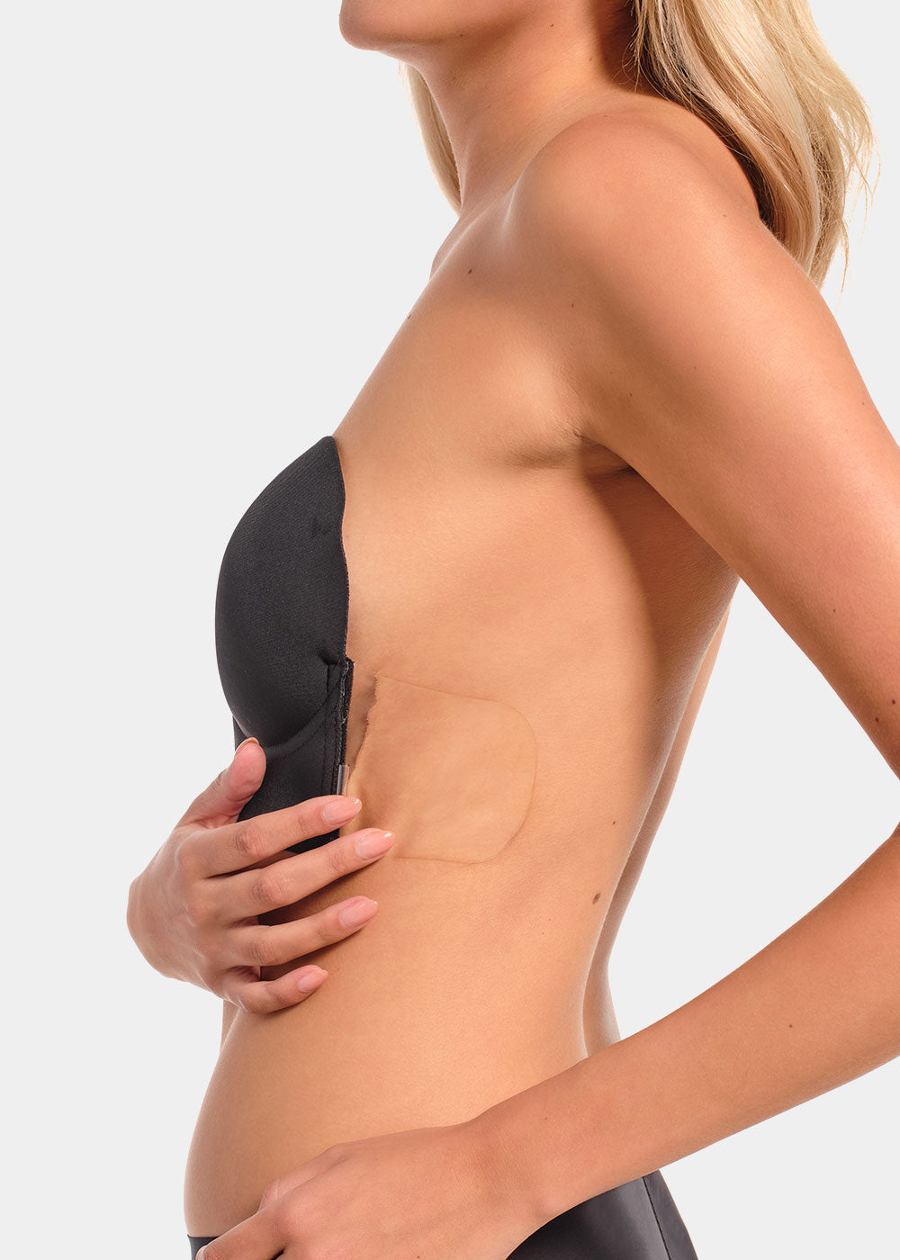 Person wearing a black strapless LUve Bra with a plain background.