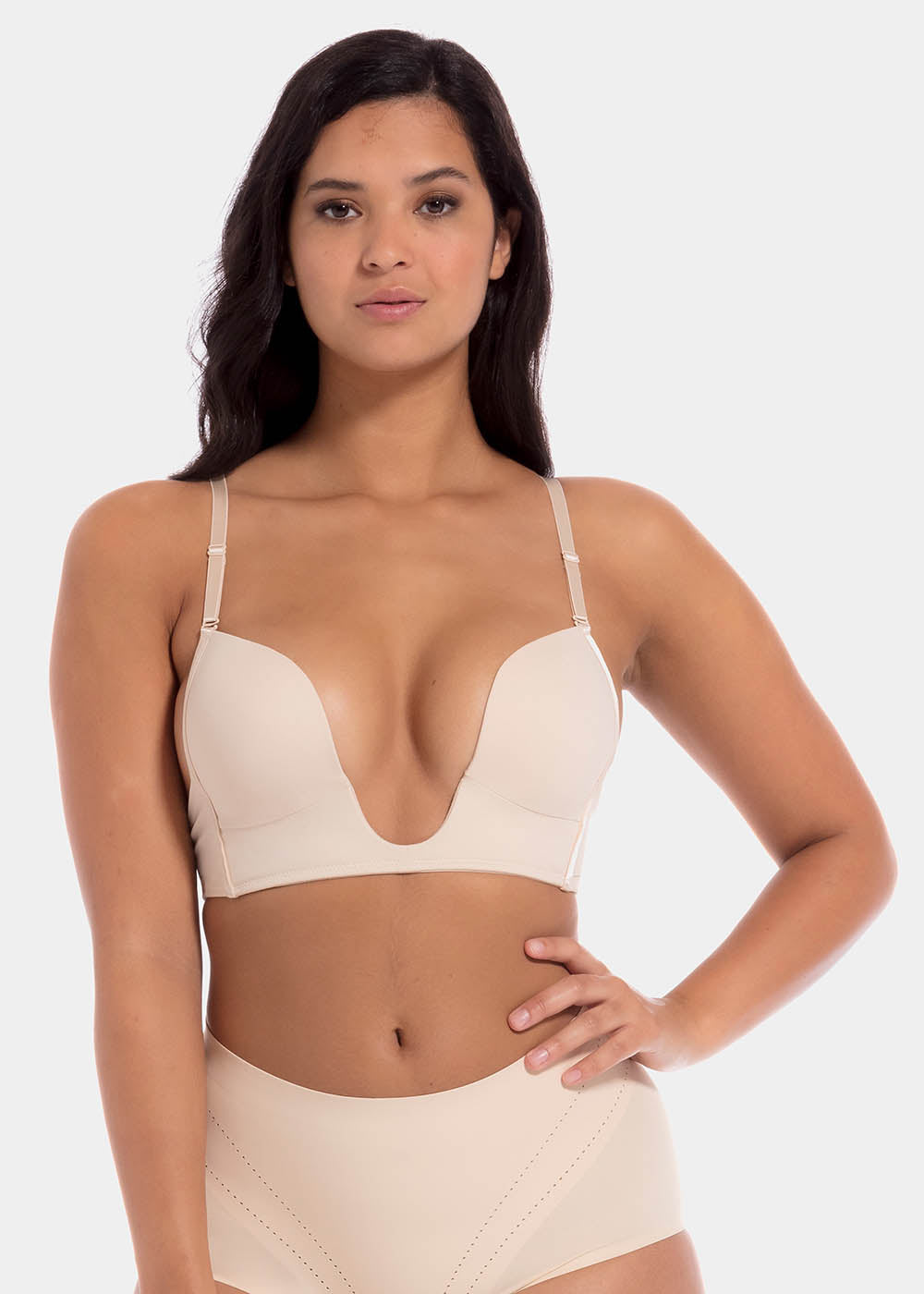 This image features a model wearing a V-Bra, which is designed to be nearly invisible under clothing with low plunge necklines. The bra boasts a deep cleavage front and an extra low back, making it ideal for seamless coverage.