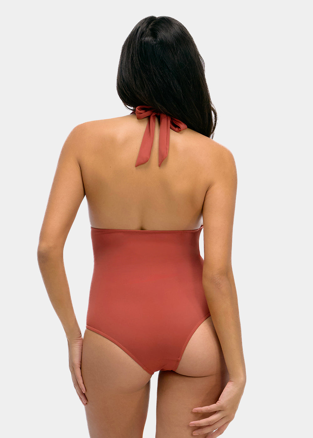Woman wearing a sunset colored one-piece swimsuit on a white background