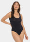 Front view of a model wearing Tone Your Body Briefer in cappuccino, sleek body-contouring briefer. Smooth powerful recycled fabric providing firm shaping for tummy, waist, and back, with seamless edges, free bust area, smooth shoulders, and hook closure visible.