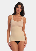 Front view of a model wearing Tone Your Body Cami in latte, body-contouring sleek cami. Smooth powerful recycled fabric providing firm shaping for tummy, waist, and back, with seamless edges, no shaping at the bust, and adjustable spaghetti straps visible.