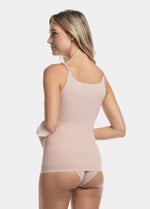 Back view of a model wearing Tone Your Body Cami in cappuccino, body-contouring sleek cami. Smooth powerful recycled fabric providing firm shaping for lower back and waist, seamless edges, and adjustable spaghetti straps visible.