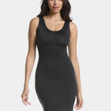 Front view of a model wearing Tone Your Body Dress in black, body-contouring tank dress. Smooth powerful recycled fabric providing firm shaping for upper body, hips, and legs, with seamless edges, smooth shoulders, and silicone-lined leg openings visible.