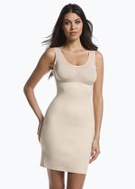 Front view of a model wearing Tone Your Body Dress in latte, body-contouring tank dress. Smooth powerful recycled fabric providing firm shaping for upper body, hips, and legs, with seamless edges, smooth shoulders, and silicone-lined leg openings visible.